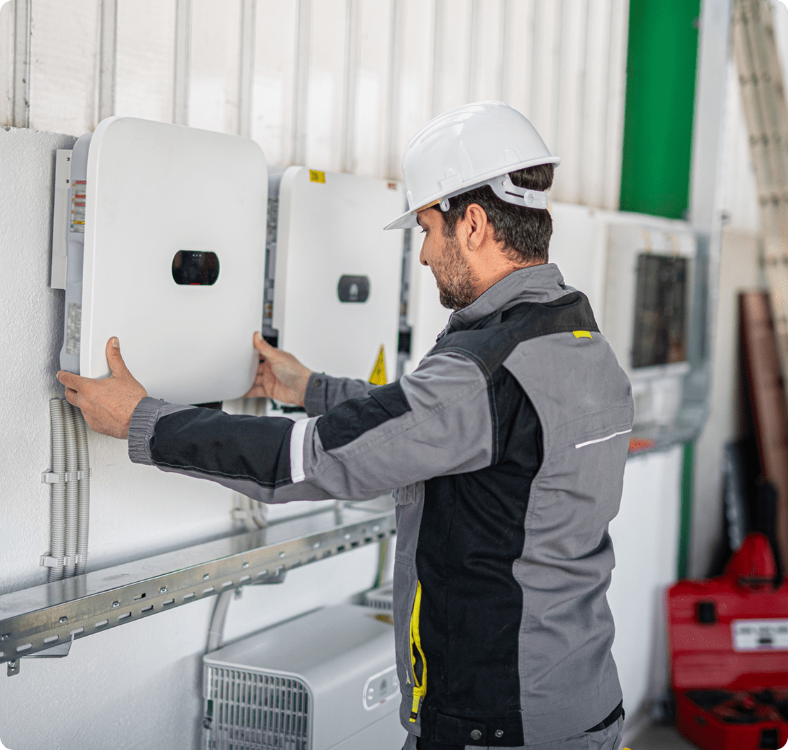 Worker adjusting electrical equipment